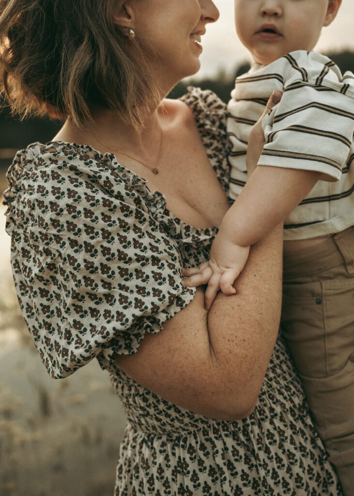 Mom holding her toddler during a family session with a Cincinnati lifestyle photographer
