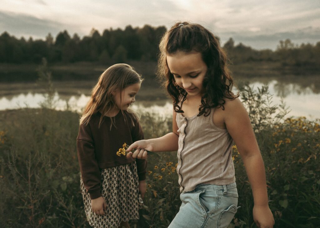 Children exploring near the pond during a storytelling session with a Cincinnati family photographer