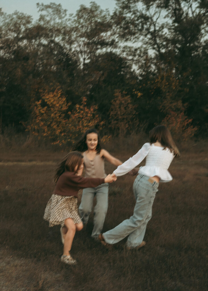 Blurry shot of girls playing ring around the rosie in Cincinnati