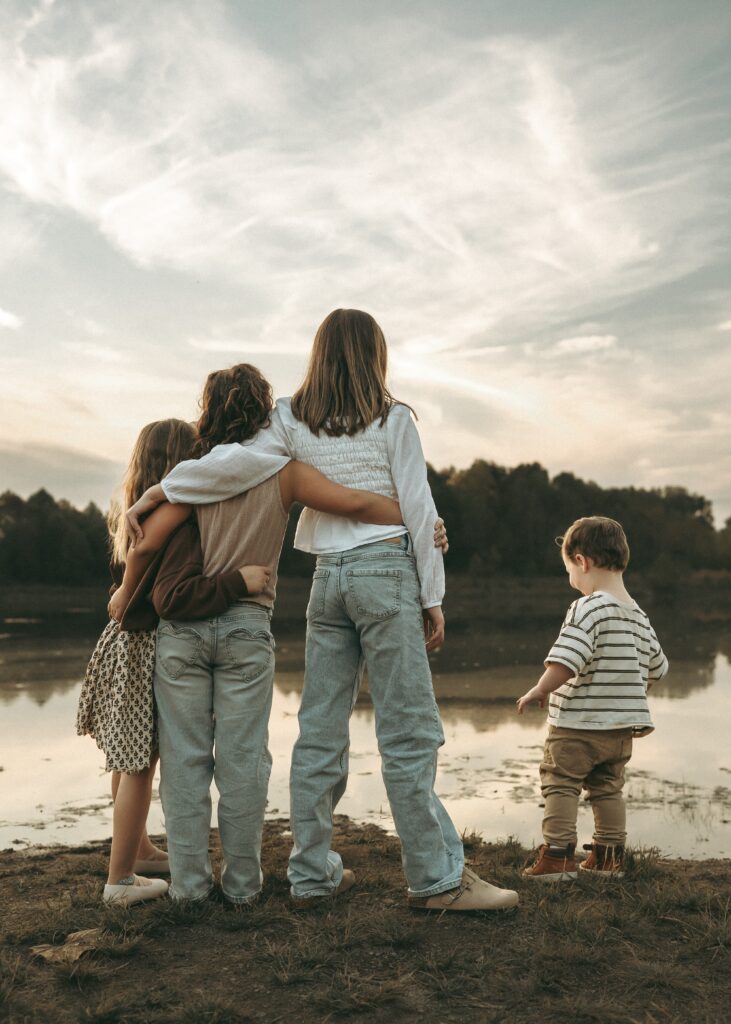 Children looking at the pond during a sunset storytelling session with a Cincinnati family photographer