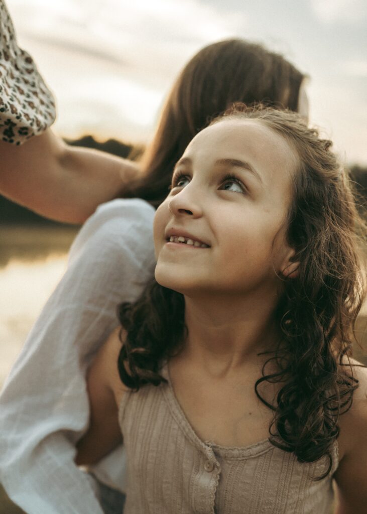 Daughter admiring mom during family photography session in Cincinnati