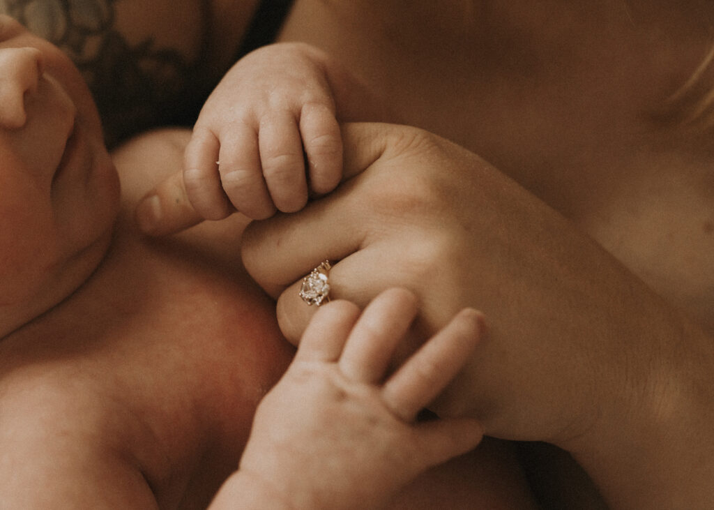 closeup of newborn and mom hand during newborn photography session in cincinnati