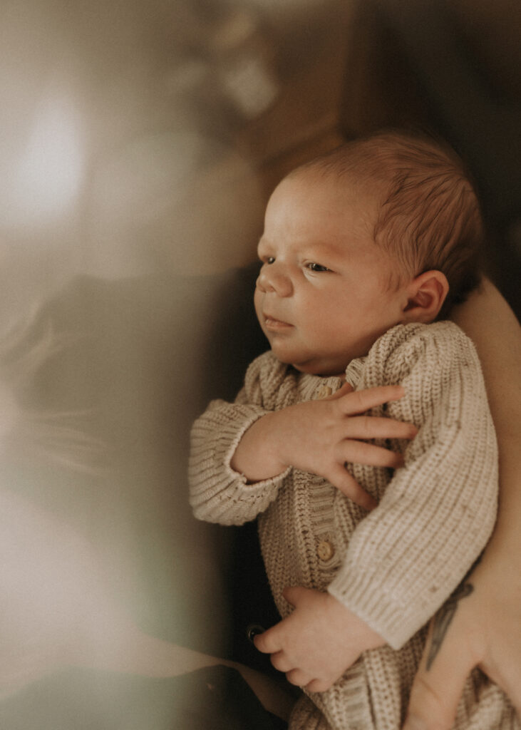 cincinnati newborn photographer artfully capturing baby looking at mom
