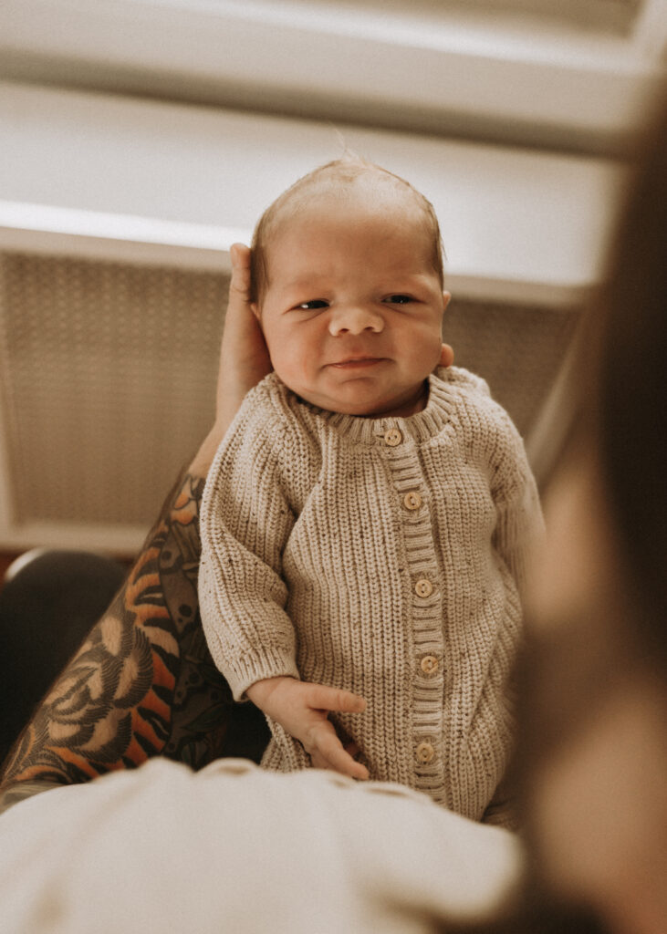 father holding newborn baby
