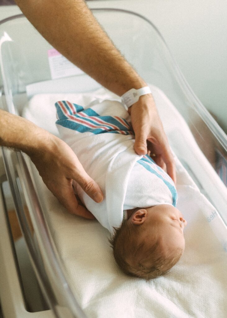 dad picking up newborn during fresh 48 session