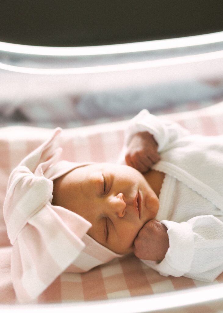 newborn girl with bow during cincinnati fresh 48 session