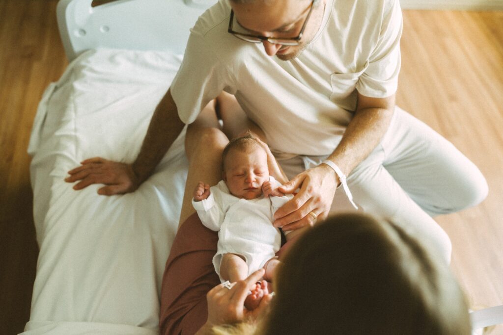 mom and dad bonding with their newborn during fresh 48 session