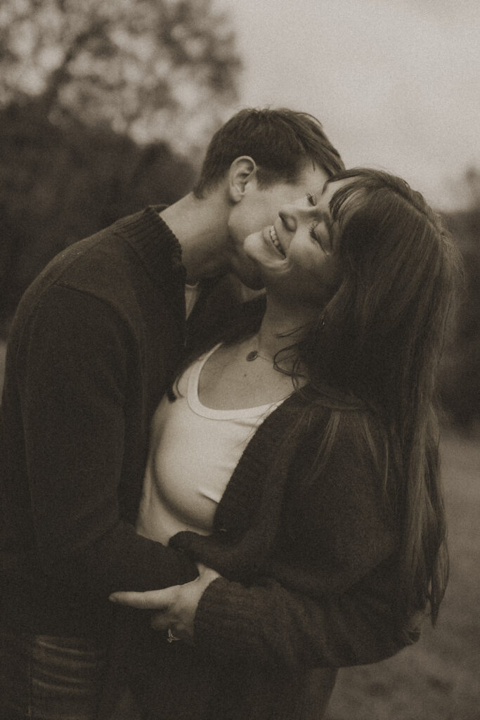 couple kissing during family photo session