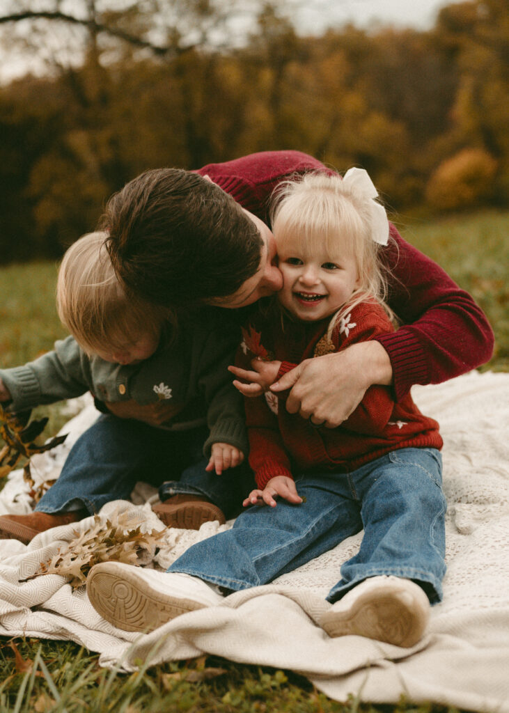 dad kissing toddler during family photos
