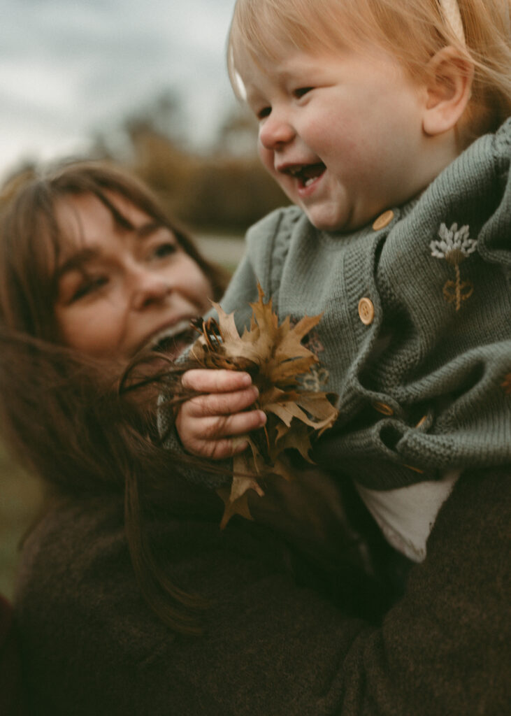 mom laughing with toddler during cincinnati family photographer session