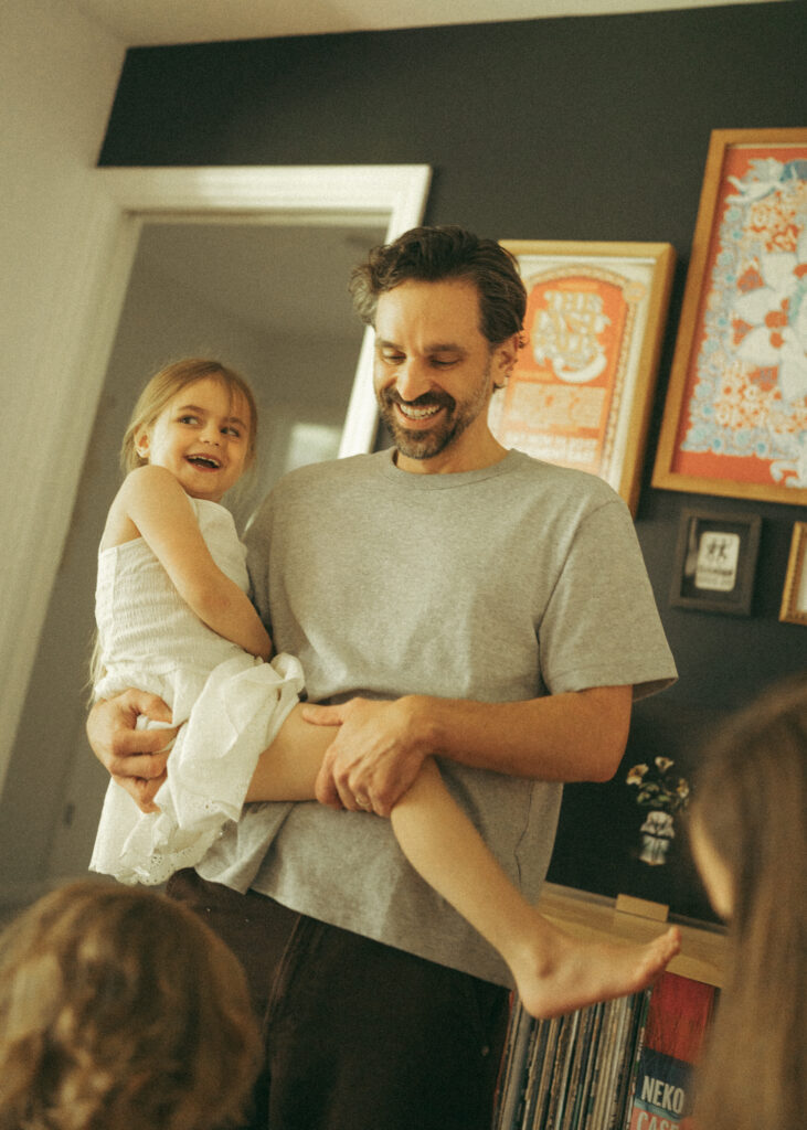 toddler girl laughing with her father during their lifestyle photography session