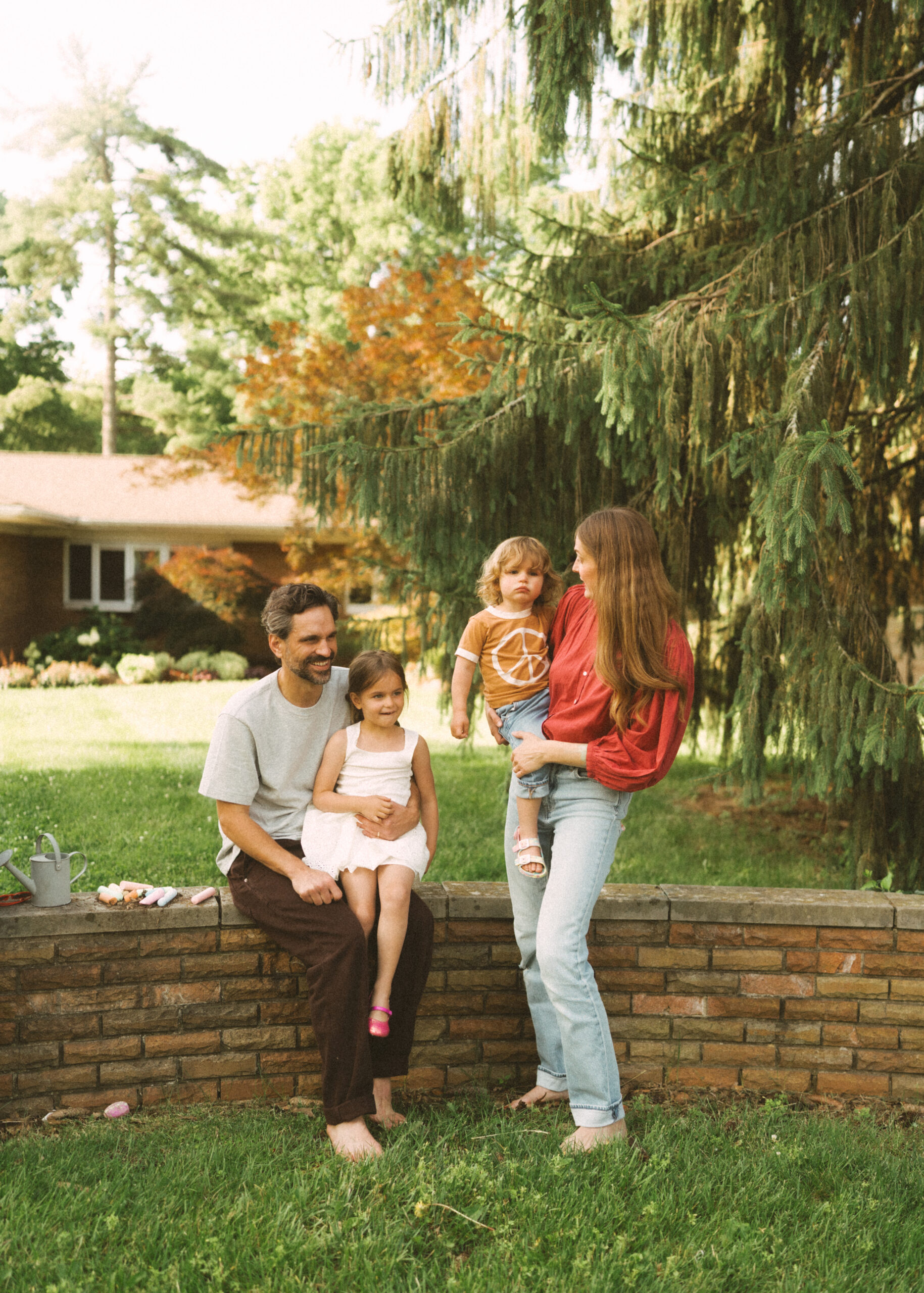 Cincinnati lifestyle photographer Sun & Vine capturing mom, dad, and their two toddlers outside their home