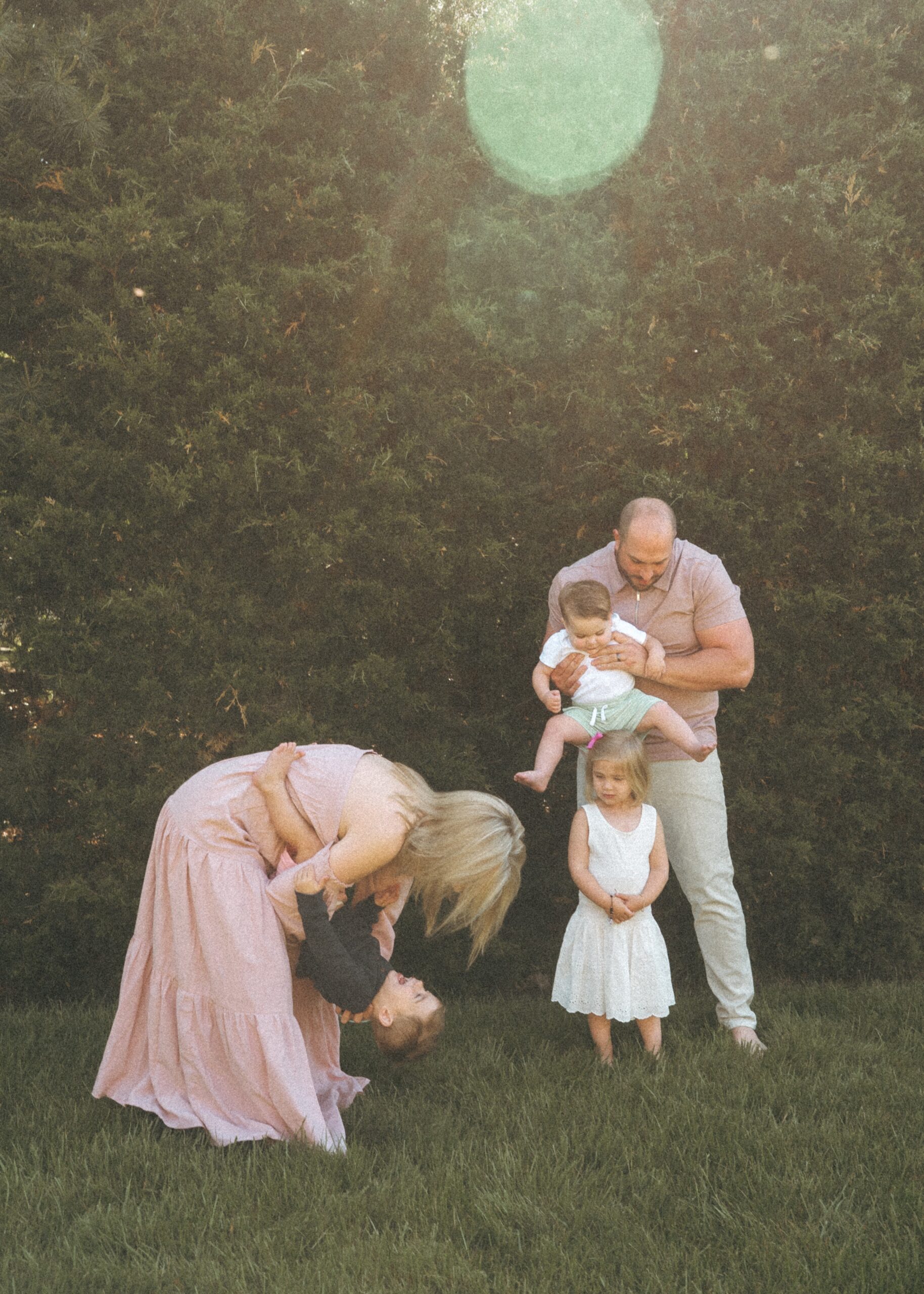 Cincinnati lifestyle photographer showcasing family playing together during their home session in their yard