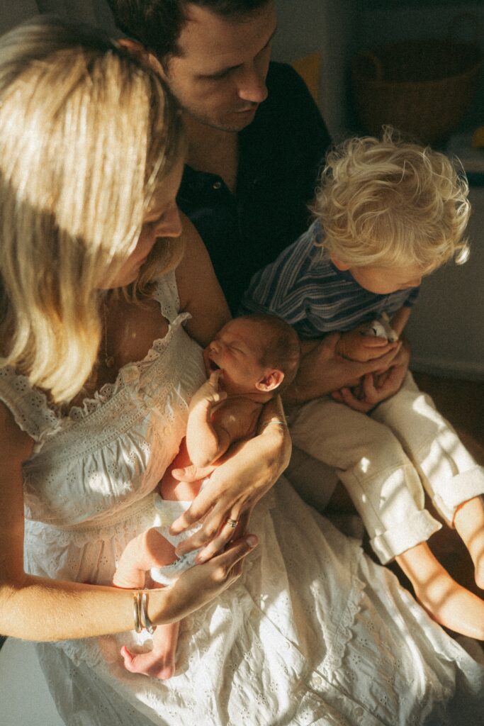 family of four snuggling in with dappled light