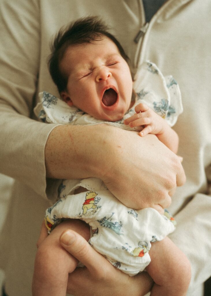 newborn baby yawning during her newborn in home lifestyle photography session