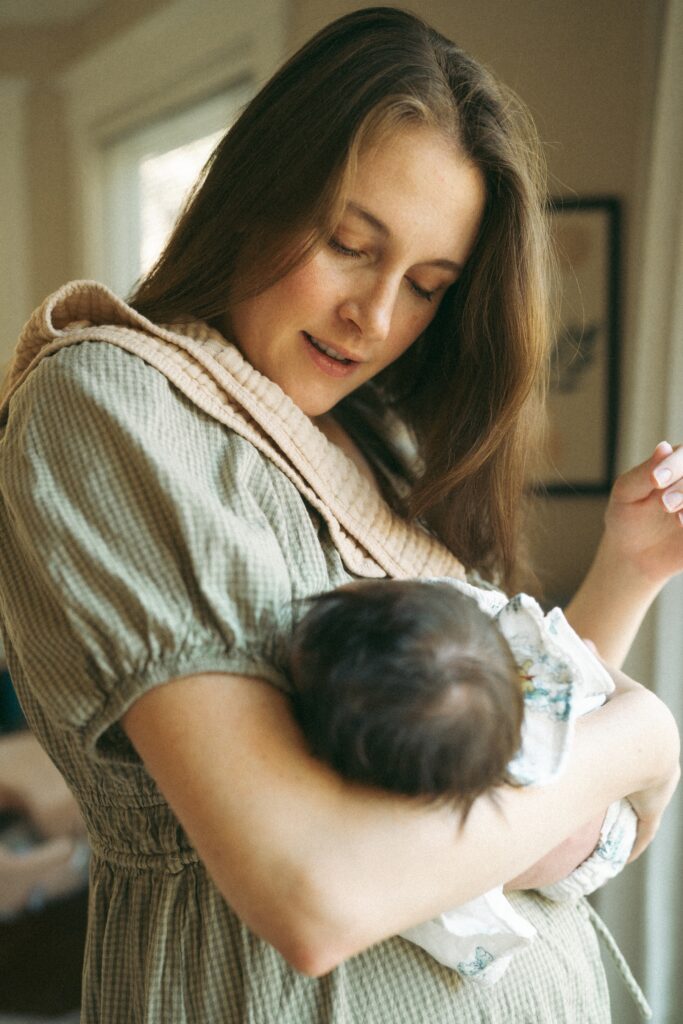 mom admiring her newborn baby girl during her cincinnati photograhy newborn session